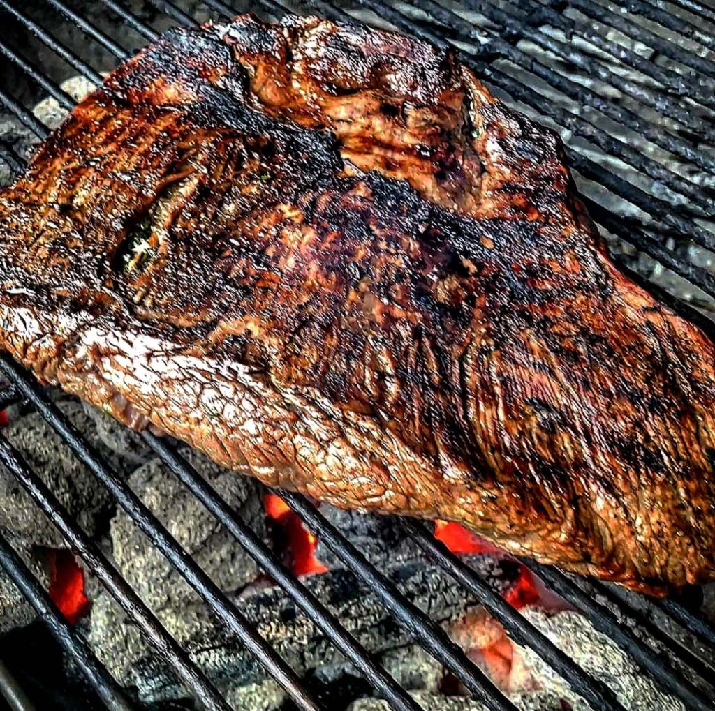 Side view of grilling flank steak